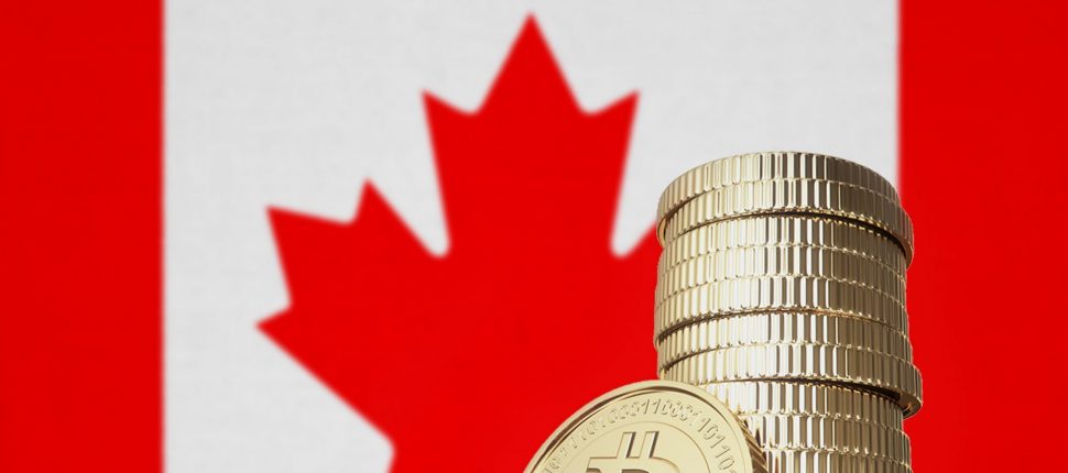 Stack of physical bitcoins with Canada flag in the background