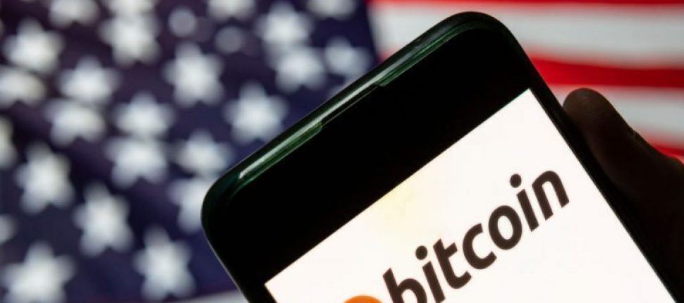 Bitcoin logo in front of a USA flag